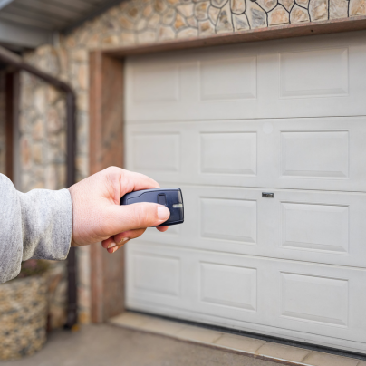Green Bay security key fob pointing to a garage door